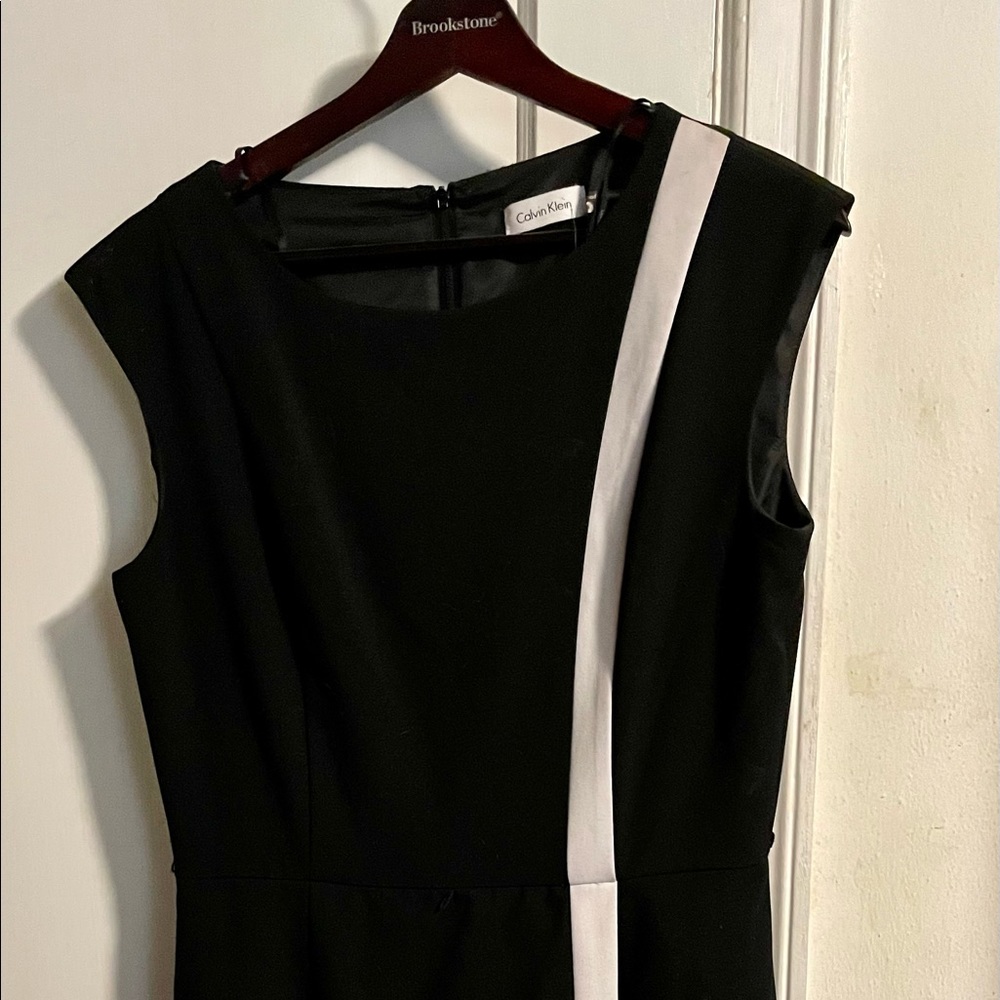 Calvin Klein black dress with white asymmetrical stripe.